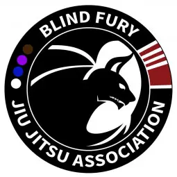 A black belt with belt rank colored dots n a circular shape. Inside of the circle is a profile of a bat